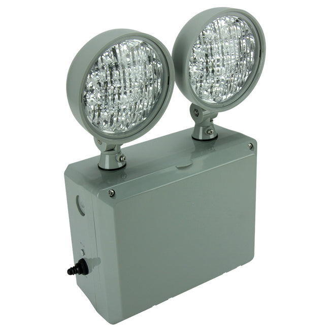 Outdoor-rated LED emergency unit mounted on wall at facility loading dock