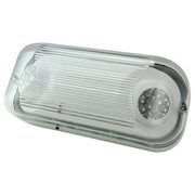 Wall-mounted LED emergency unit installed on industrial exterior with waterproof hardware