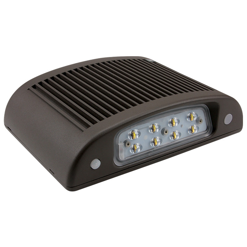 Slim LED wall pack with exposed lens and ribbed aluminum housing for thermal management