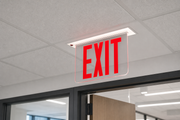 NYRELZXTE recessed NYC edge-lit exit sign with red letters installed in a commercial ceiling above a doorway