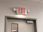 Exitronix 400C red brushed aluminum exit emergency combo installed above an exit door for SKU 400C-1-BA
